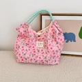 Close-up of pink floral quilted tote bag featuring mint green rope handles and logo - Lusi Portrait