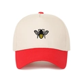 Detail of bee embroidery on a cream and red contrast panel five-panel trucker hat - Red