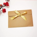 Brown kraft paper envelope with elegant golden silk ribbon bow for gift cards - Envelope with Gold Ribbon
