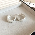 Macro detail of matte silver earrings with black polka dots in a beige fabric jewelry box - 48# Matte Silver Black Polka Dot Hoop Silver Earring Post