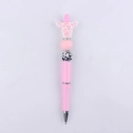 Detail of pink cow-themed DIY beaded pen with silicone charms and rhinestone spacers - Pink
