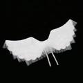 Detail of white mesh angel wings showing translucent layers and elastic straps - White Mesh Wings
