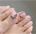 Nude press-on toe nails featuring elegant black leaf patterns for a stylish pedicure - 1641-Black Leaf Graffiti