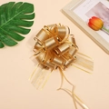 Detail of a large gold tree texture pull bow with mesh ribbon and elegant gold trim - Gold