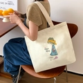 Off-white canvas tote bag featuring a girl illustration and Nice Day artistic text - Girl with Straw Hat with Beige Strap