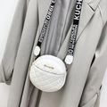 White quilted circular crossbody bag with wide printed strap on grey trench coat - White