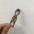 Brown minimalist fish-shaped U-hairpin for bun styling shown held in hand - Large Fish Tail Hair Stick / Dark Gray