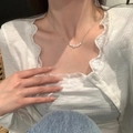 Close-up of a delicate silver bow necklace with zircon stars on a model's collarbone - Exquisite Zircon Star Necklace
