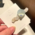 Mermaid style shell hair clip with iridescent pearl finish on a display card - 10# Wavy Large Shell - Blue