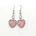 Macro detail of heart-shaped pink glitter earrings with polished silver metal frames - Iridescent Pink (Color 24)