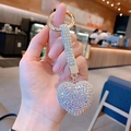 Close-up of a sparkling rhinestone heart keychain held in hand to show scale - AB Rainbow
