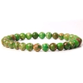 Macro detail of 6mm natural green stone beads with unique marbled texture on elastic bracelet - Green Emperor Stone