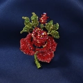 Vintage gold-toned rose brooch with red and green rhinestones on dark blue silk - Red