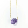 Detailed view of large irregular natural purple crystal pendant with a gold chain - Deep Amethyst