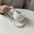 Hand-painted white ceramic coffee cup with red heart pattern and twisted handle - Small Hearts Cup & Saucer Set / Cup + Saucer Set