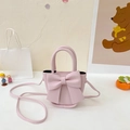 Mini light pink crossbody bag with large bow detail and matte PU leather finish - Pink