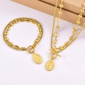 Detailed view of golden double-layered necklace set with relief coin pendant and OT toggle - Necklace + Bracelet