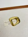 Macro detail of minimalist irregular golden metal brooch with polished mirror finish - 11 Gold Hollow Pin (XZ0011A)