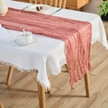 Wrinkled dusty pink cheesecloth table runner over white waffle tablecloth with tassels - Dust Rose