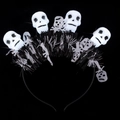 Halloween headband with four glowing white skulls and black and white tassels on a black frame - Skull Headband with Tinsel Fur