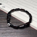 Ethnic ebony wood bracelet with rectangular beads and patterned Dzi bead on vintage book - Ebony 7X13mm Single Loop With Dzi Bead
