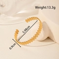 Adjustable golden stainless steel cuff bracelet featuring a stamped heart pattern texture - Continuous Heart Stamped