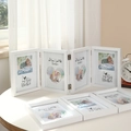 Minimalist white four-fold photo frame in MDF wood with hinges and baby-themed photo inserts - Quadruple Fold - White