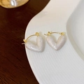 Elegant gold heart earrings with white marble texture on a white ceramic tray - White Drip Oil Hoop