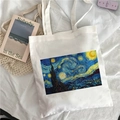 White canvas tote bag featuring Van Gogh Starry Night art print on soft bedsheet background - Van Gogh Starry Night