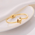 Elegant gold-tone open cuff bracelet featuring a frosted butterfly and zircon stone inlay - Butterfly Bangle / Gold