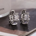 Silver hoop earrings featuring square micro-set zircons and polished pavé details - Silver