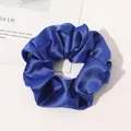 Close-up of royal blue silk satin scrunchie with smooth texture on white background - Sapphire Blue
