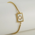 Adjustable gold box chain bracelet with white shell pendant featuring letter O detail - Letter O