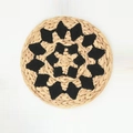 Handwoven round boho wall decor featuring a black floral pattern on natural fiber - Type F (Black Radial Floral)