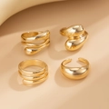 Detail of four-piece gold irregular bangle bracelet set with smooth minimalist finishes - Minimalist Fluid Ring Set (04 Light Gold 5680)