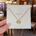 Golden butterfly pendant necklace with delicate bead chain on a fashion card display - X072 Gold Bow Pendant