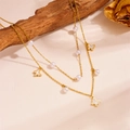 Detail of double-layer gold necklace with pearls and white butterfly charms on wood - Butterfly Style (D211)