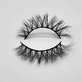 Close-up of thick curly black faux mink eyelashes with natural wispy crisscross style - D252