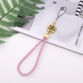 Pink leather braided phone strap with gold plum flower pendant and magazine background - Pink