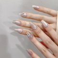 Detailed view of silver-pink cat eye press-on nails with 3D butterfly and rhinestone accents - 1432 Short Coffin (XS)