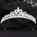Detailed view of bridal tiara with sparkling crystal leaves and floral metal patterns - Silver with White Rhinestones