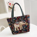 Ethnic style black canvas tote bag featuring colorful elephant embroidery and floral patterns - Floral Sea Elephant