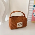 Brown corduroy square handbag featuring a cute cartoon bear patch and zip closure - Brown