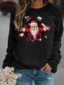 Outdoor shot of a woman wearing a black long-sleeve Christmas sweatshirt with Santa print - S / Tops / Black