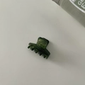 Top view of a dark green twill acetate hair claw clip on a clean white surface - Small Size 1