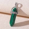 Macro detail of hexagonal green stone pendant with a polished silver metal bail - Malachite