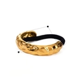 Detailed view of golden irregular hammered alloy metal hair ring with black elastic band - Rippled Single Tube