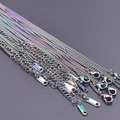 Detailed macro view of 2.2mm rainbow stainless steel chain necklaces with 925 hallmarks - Colorful
