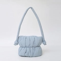 Modern light blue puffy nylon bucket bag with shoulder strap knot details and cloud-like texture - Sky Blue