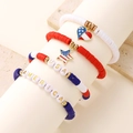 Detail of USA and AMERICA polymer clay bracelets with gold beads and enamel flag charms - USA Heart Style (1203)